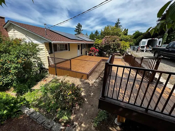 Wood deck builders Federal Way WA — cedar deck with black railing in a residential backyard